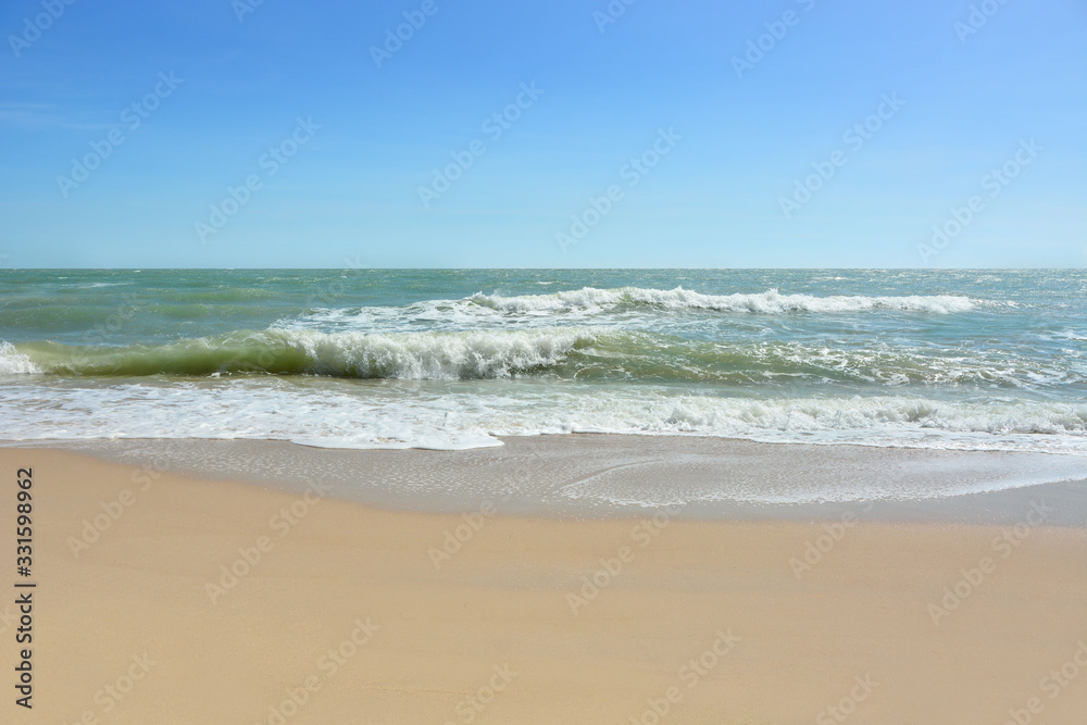 Wave of the sea on the sand beach, Beach and tropical sea, Paradise idyllic beach, Summer holidays, Ocean in the evening as nature travel background.