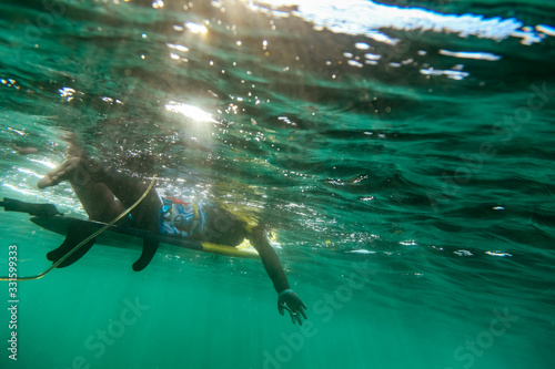 Under water view of surfer