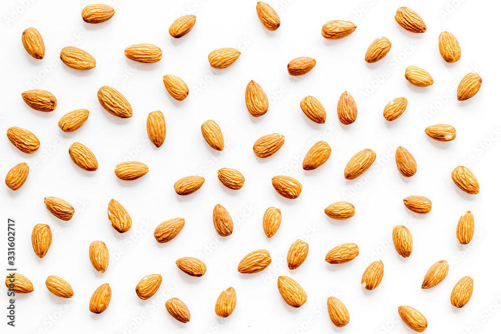 Almond kernels background on white table top-down Almond kernels background on white table top-down