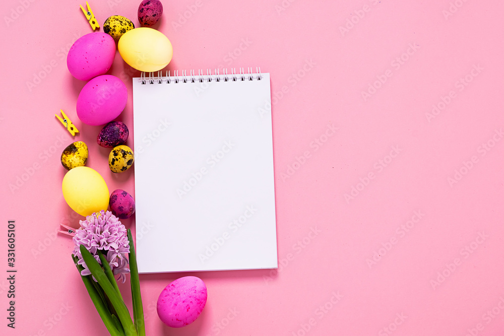 Happy easter concept. Festive spring layout of eggs clean notebook flowers on a pink background. Copy space. Happy easter concept. Festive spring layout of eggs clean notebook flowers on a pink background. Copy space.