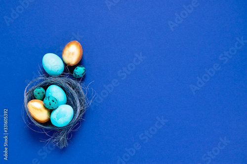 Happy easter concept. Festive spring composition blue small big eggs in a nest on a fashionable minimalistic background.