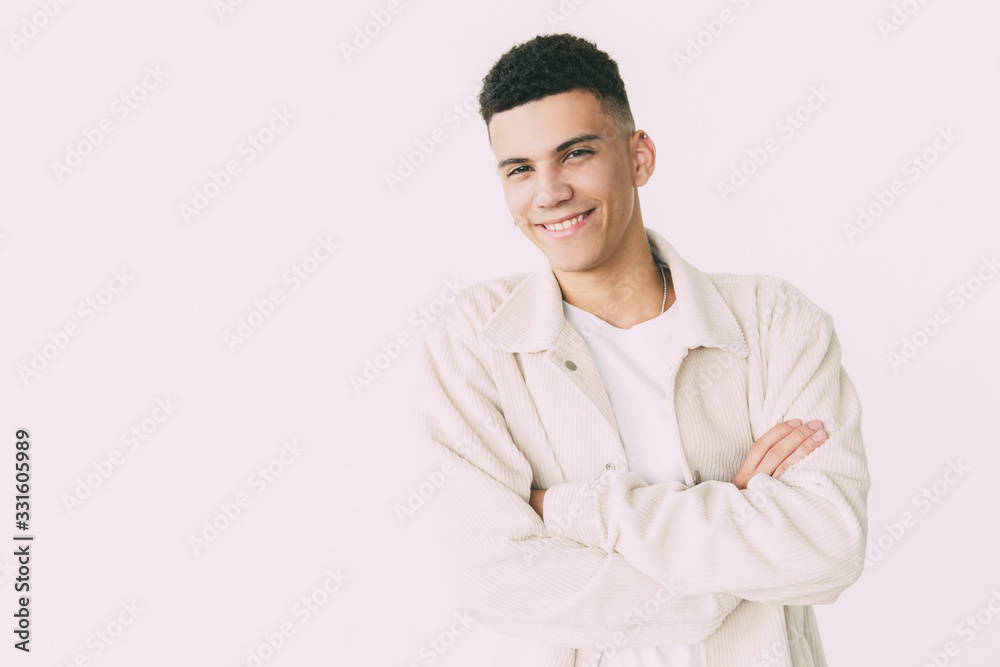 Confident young man smiling at camera. Portrait of handsome happy young man standing with crossed arms and looking at camera. Gesture concept Confident young man smiling at camera. Portrait of handsome happy young man standing with crossed arms and looking at camera. Gesture concept