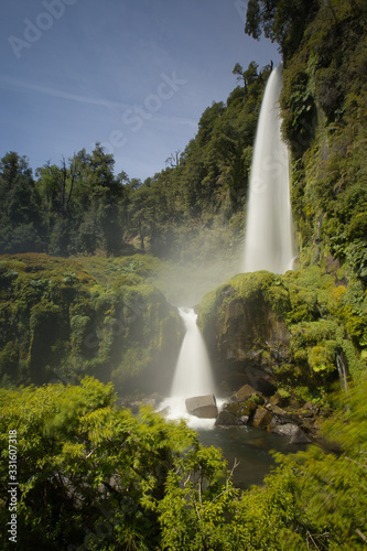 Beautiful Patagonian waterfall in a forest lit by the rising sun of Patagonia