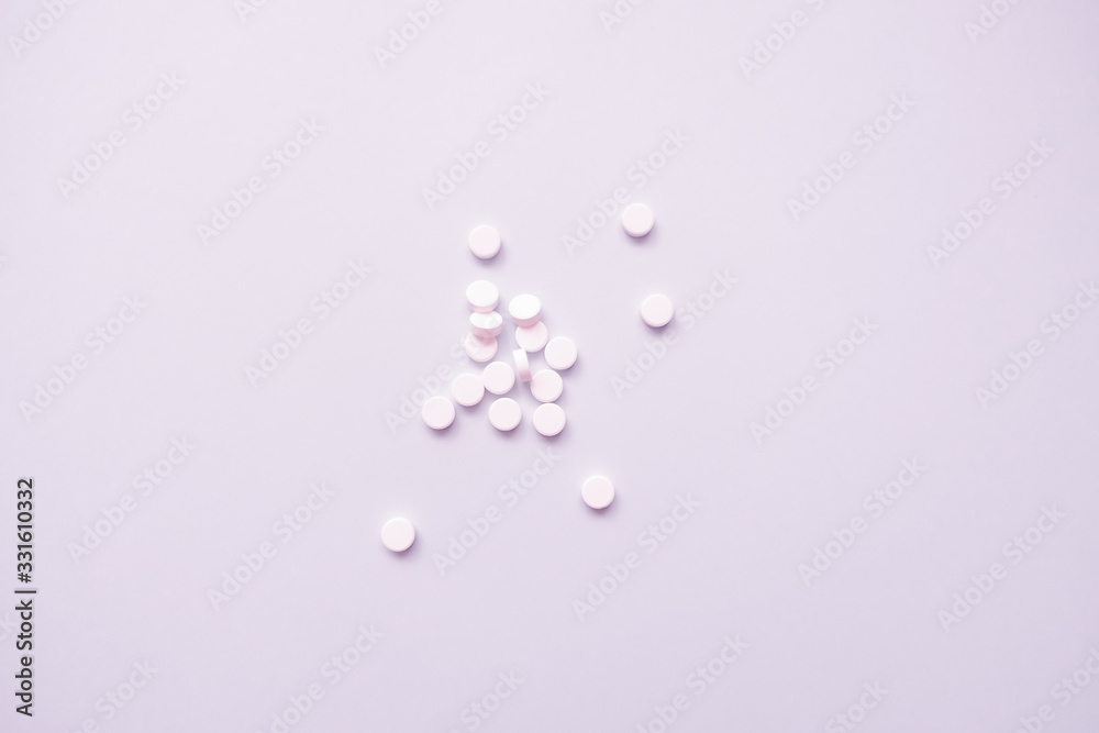 many white pills on a light background many white pills on a light background