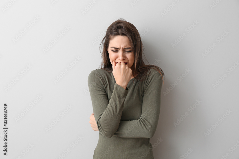 Depressed young woman on light background Depressed young woman on light background