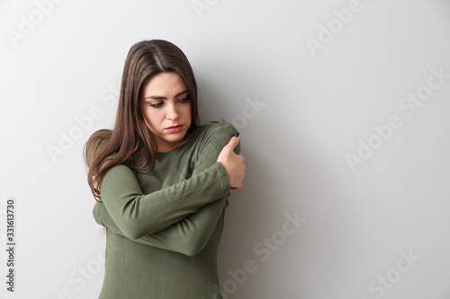 Bilde på lerret Depressed young woman on light background