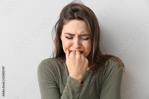 Obraz na plátně Depressed young woman on light background