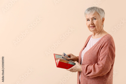 Senior woman with wallet on...