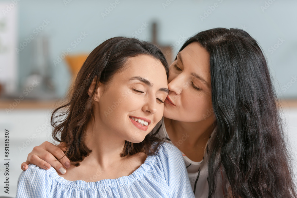 Adult daughter with her mother spending time together at home Adult daughter with her mother spending time together at home