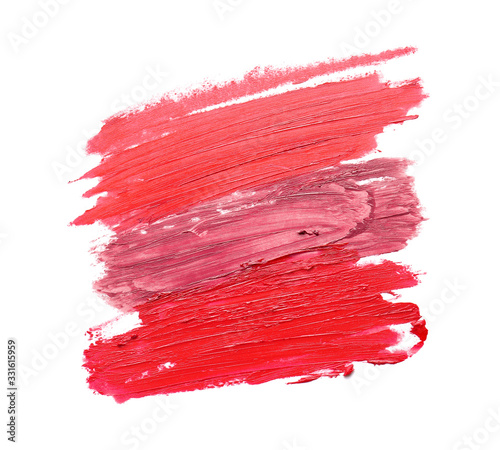 Strokes of bright lipsticks on white background