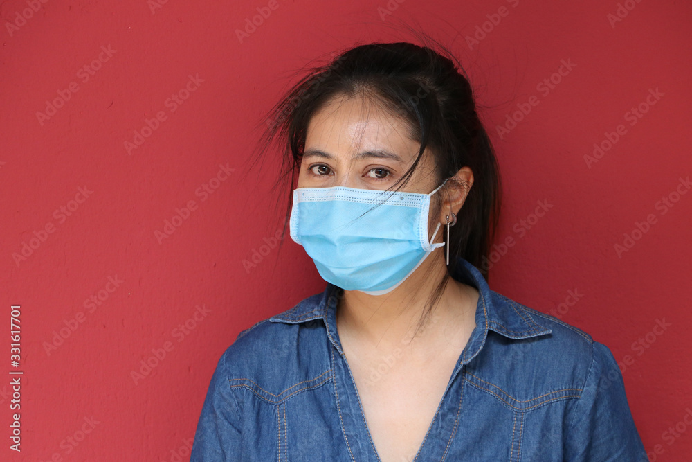 Masked Asian woman prevent germs on red background. Tiny Particle or virus corona or Covid 19 protection. Masked Asian woman prevent germs on red background. Tiny Particle or virus corona or Covid 19 protection.