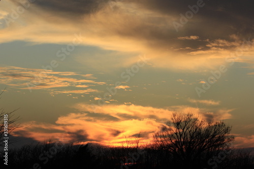 Sunset with clouds out in the country in Kansas.