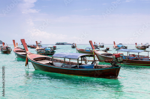 Traditional long tail boat on white sand beach in Thailand. Travel and Holiday concept, Tropical beach, long tail boats, gulf of Thailand. Long boat and tropical beach, Andaman Sea.