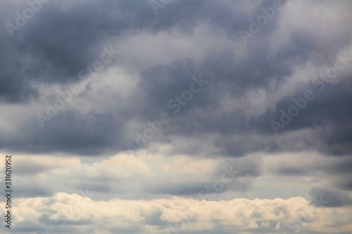 Fototapeta Naklejka Na Ścianę i Meble -  cloudy sky with heavy rain clouds and light on the horizon