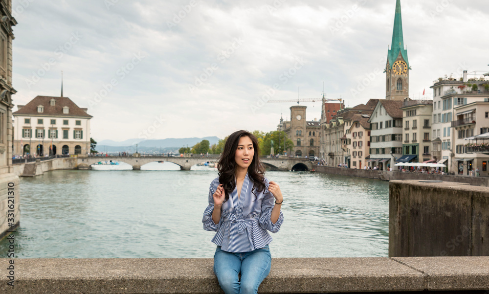 Europe city woman traveller lifestyle. Travel Europe summer holiday girl enjoying her holiday. Young Asian Girl relaxing in Europe city. Vacation and Holidays in Zurich and Europe concept.