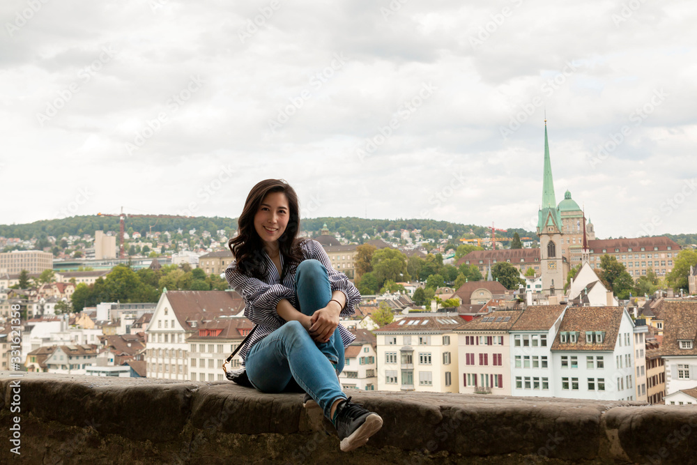 Europe city woman traveller lifestyle. Travel Europe summer holiday girl enjoying her holiday. Young Asian Girl relaxing in Europe city. Vacation and Holidays in Zurich and Europe concept.