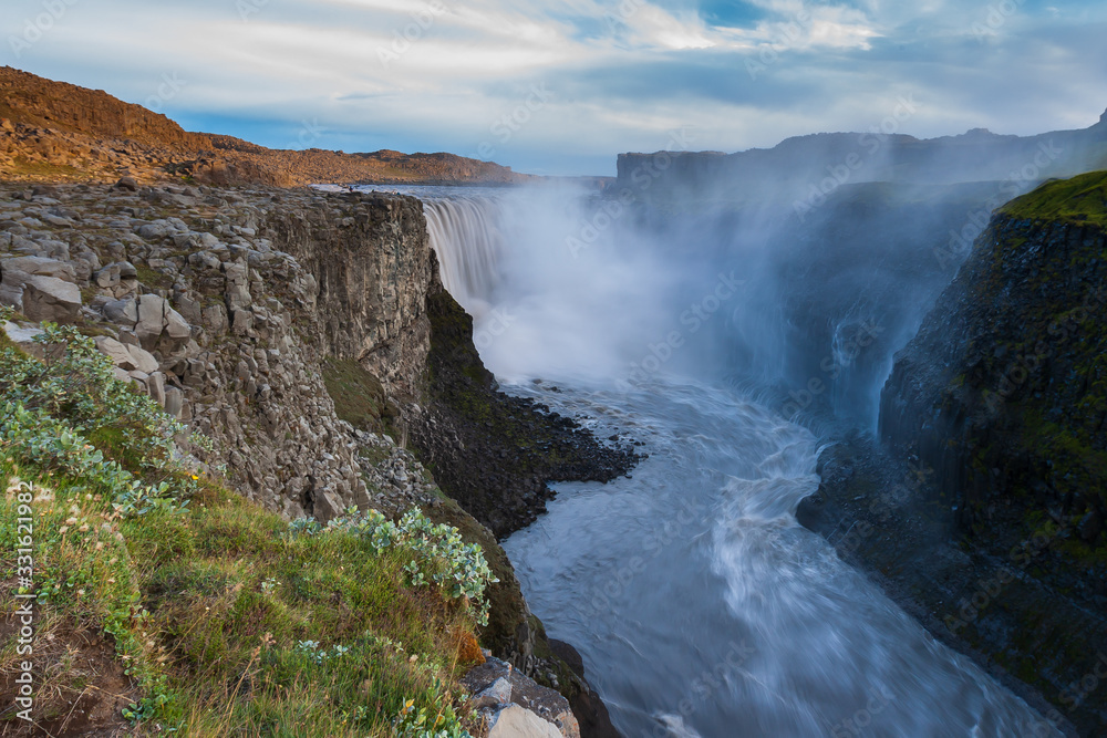 Beautiful Icelandic waterfall at sunset with huge quantity of flowing waters Iceland Beautiful Icelandic waterfall at sunset with huge quantity of flowing waters Iceland