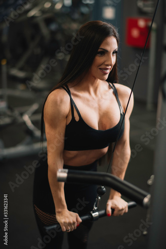 Fitness woman on training. Young woman in the gym. 
