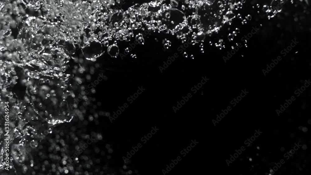 Water bubble rising to the surface in black background Water bubble rising to the surface in black background