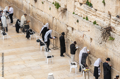 Fototapeta Jewish believers pray near the Kotel in the Old Town of Jerusalem in Israel