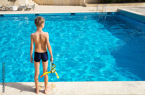 Boy with mask and swimming pool.