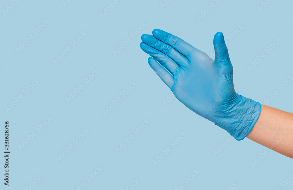 Doctor hand glove shows number five front on blue background. Doctor hand glove shows number five front on blue background.