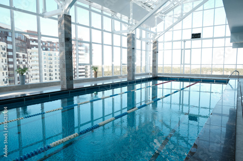 Modern swimming pool with clean water and lane divider in health club, sport and spa concept © pressmaster