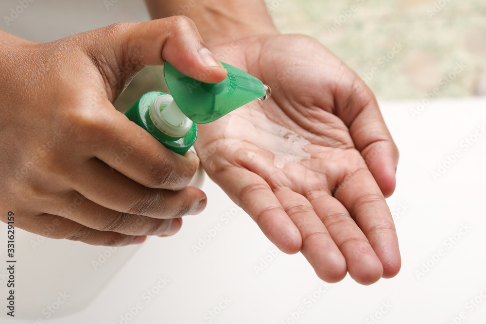 Female hands using washing hand with Alcohol Sanitizer to protect themselves from virus infection in Corona virus