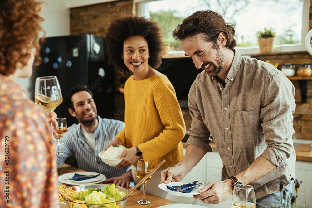 Group of young happy people gathering for lunch at dining table. Group of young happy people gathering for lunch at dining table.