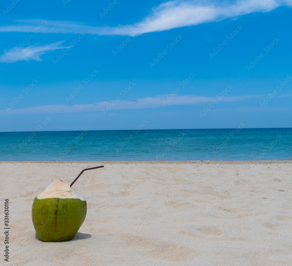 Refreshing coconut on a beautiful sandy beach Refreshing coconut on a beautiful sandy beach