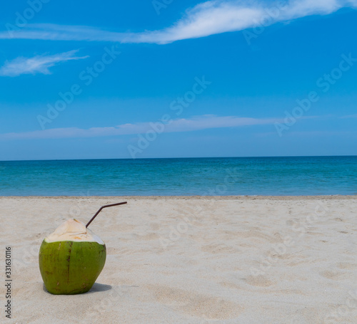 Refreshing coconut on a beautiful sandy beach