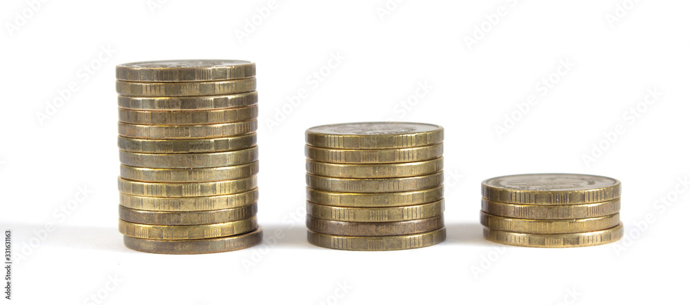 Three columns of metal coins were one in a descending order on a white background. Three columns of metal coins were one in a descending order on a white background.
