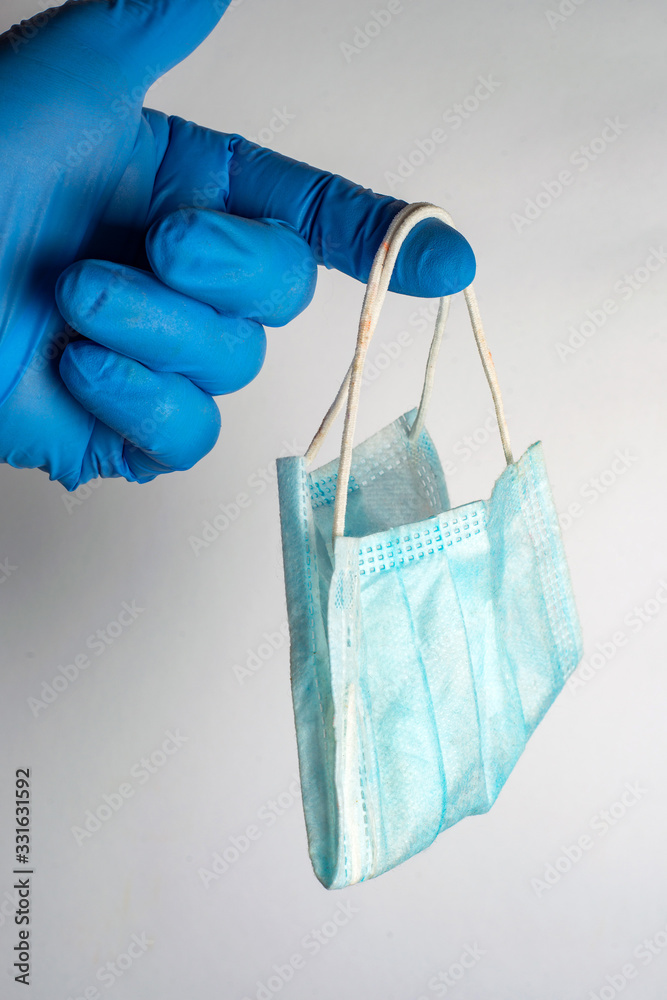 used respirator to protect the respiratory system from viral infection in the hand of a medical professional