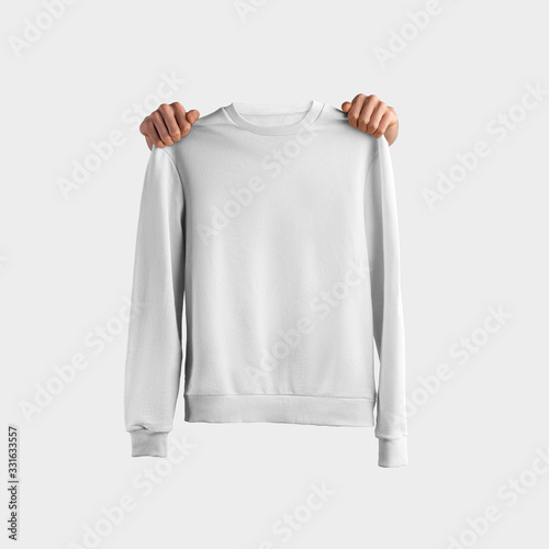 Εκτύπωση καμβά Mockup of white textile sweatshirt with arm holding clothes, front view, isolated on background