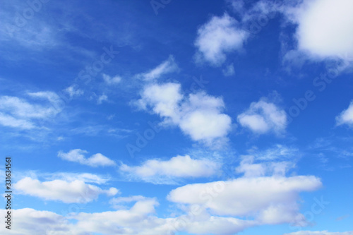 Beautiful blue sky and white cumulus and cirrus clouds. Background. Scenery.