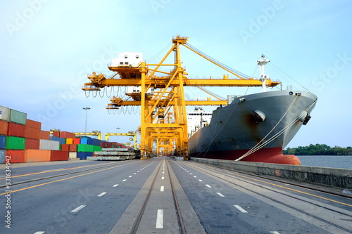 Logistic system on transportation with giant crane working unload container from cargo ship on terminal, import and export on shipping