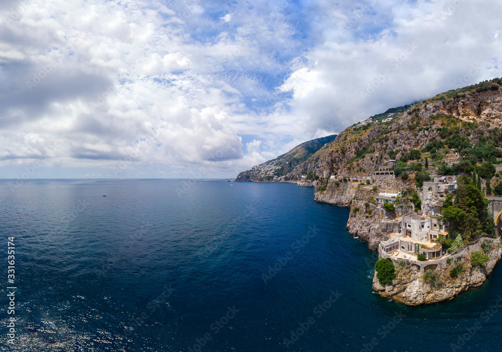 Aerial view of the rocky seashore of southern Italy. Incredible beauty panorama of mountains and sea. Travel and tourism. Sunny summer day. Fiordo di furore beach. Praiano, Amalfi coast.