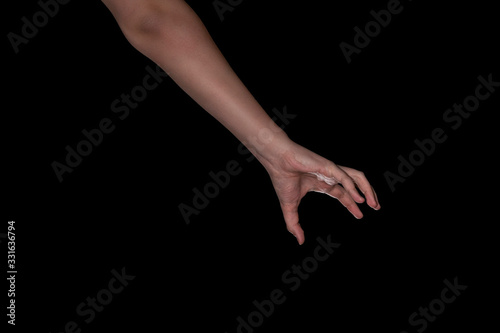 hand of a young man on a black background. grabbing something gesture