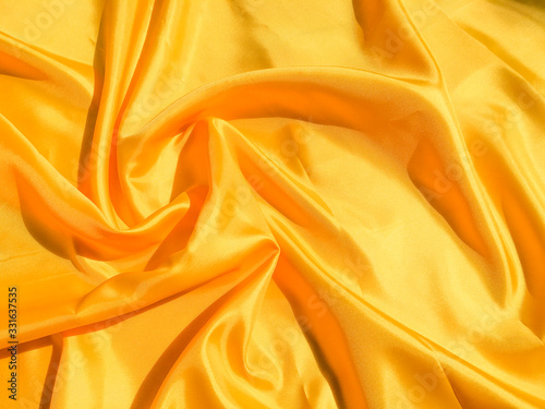 Beautiful yellow silk or satin texture background with copy space for design and artwork