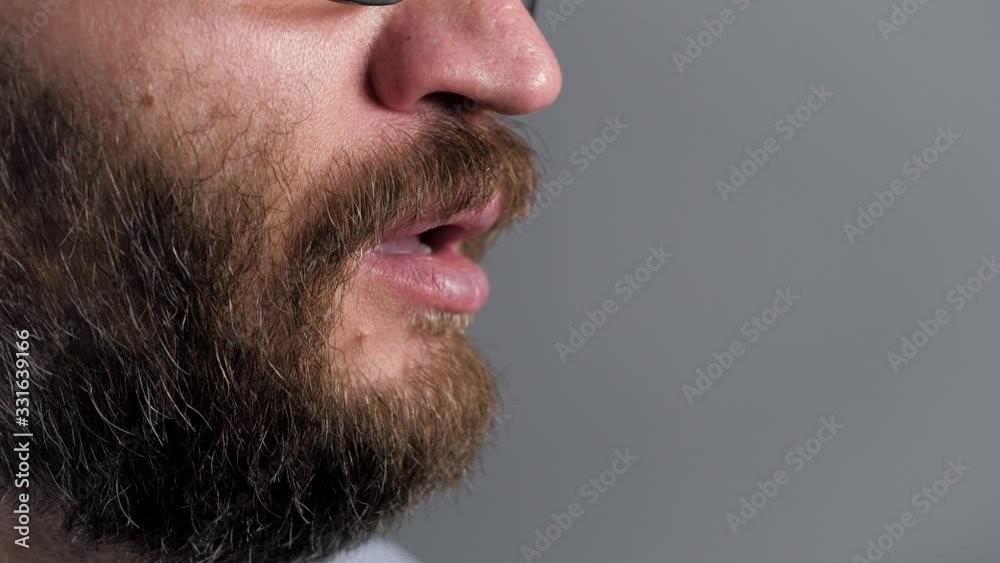 Man sneezes and closes her mouth with paper towel. Allergies, cat hair, dust, colds, flu, rhinitis concepts. Side view. Close-up Man sneezes and closes her mouth with paper towel. Allergies, cat hair, dust, colds, flu, rhinitis concepts. Side view. Close-up