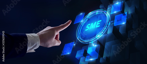 The concept of business, technology, the Internet and the network. A young entrepreneur working on a virtual screen of the future and sees the inscription: SME