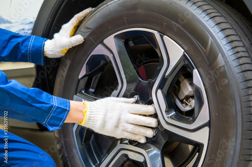 Car mechanic changing tire in professional car repair,Car Maintenance in the Professional Service.