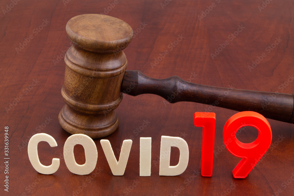 Judge's gavel with word covid19. Concept of quarantine and law against covid-19. Judge's gavel with word covid19. Concept of quarantine and law against covid-19.