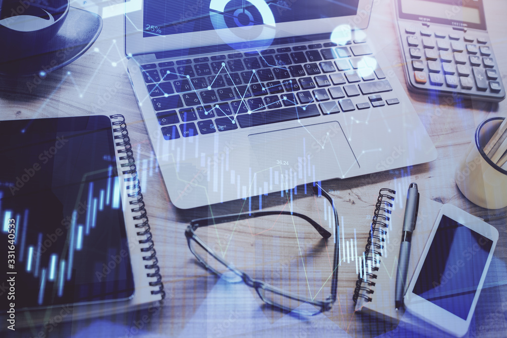 Forex market chart hologram and personal computer background. Double exposure. Concept of investment. Forex market chart hologram and personal computer background. Double exposure. Concept of investment.