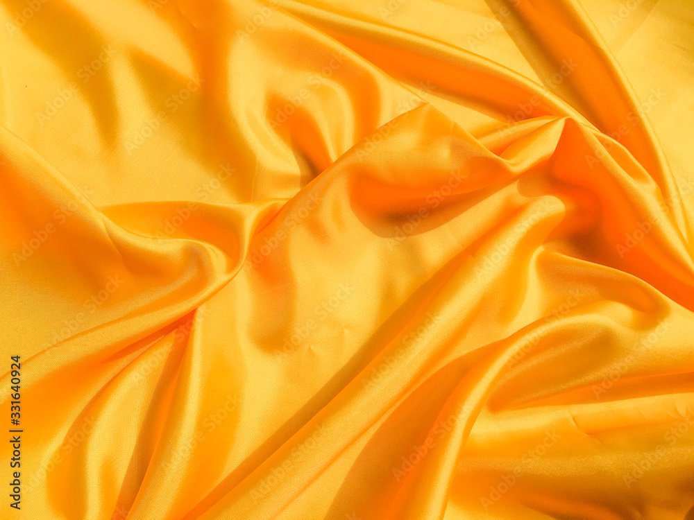 Yellow silk or satin texture background with copy space for design Yellow silk or satin texture background with copy space for design