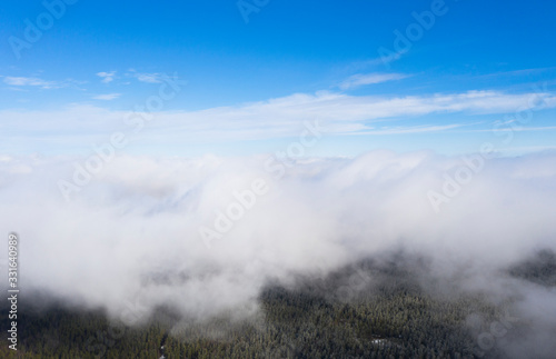 Aerial view clouds over the forest and lake. View from drone. Aerial top view cloudscape. Texture of clouds. View from above. Sunrise or sunset over clouds