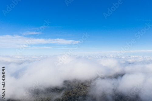 Aerial view clouds over the forest and lake. View from drone. Aerial top view cloudscape. Texture of clouds. View from above. Sunrise or sunset over clouds