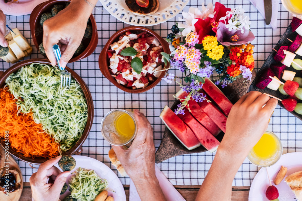 Φωτογραφία Top view of group of friends having fun together in a healthy vegetarian fresh s