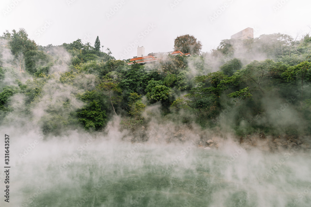 The famous Beitou Thermal Valley in Beitou Park, boiling steam from hot spring floating through the trees in Taipei City, Taiwan