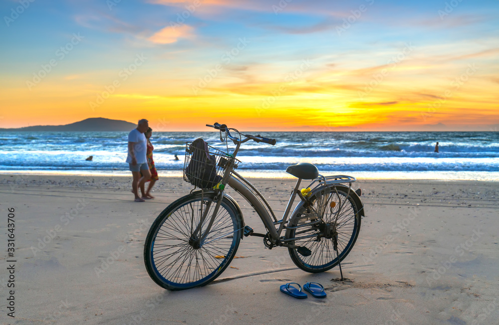 Fototapeta premium A bike by the beautiful beach at dawn, this is a means for a coastal walk of fishermen